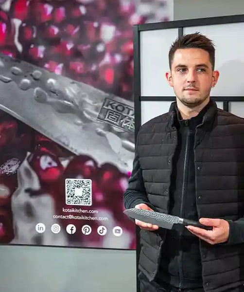 Chef Matthieu Pasgrimaud holding a KOTAI Santoku knife.