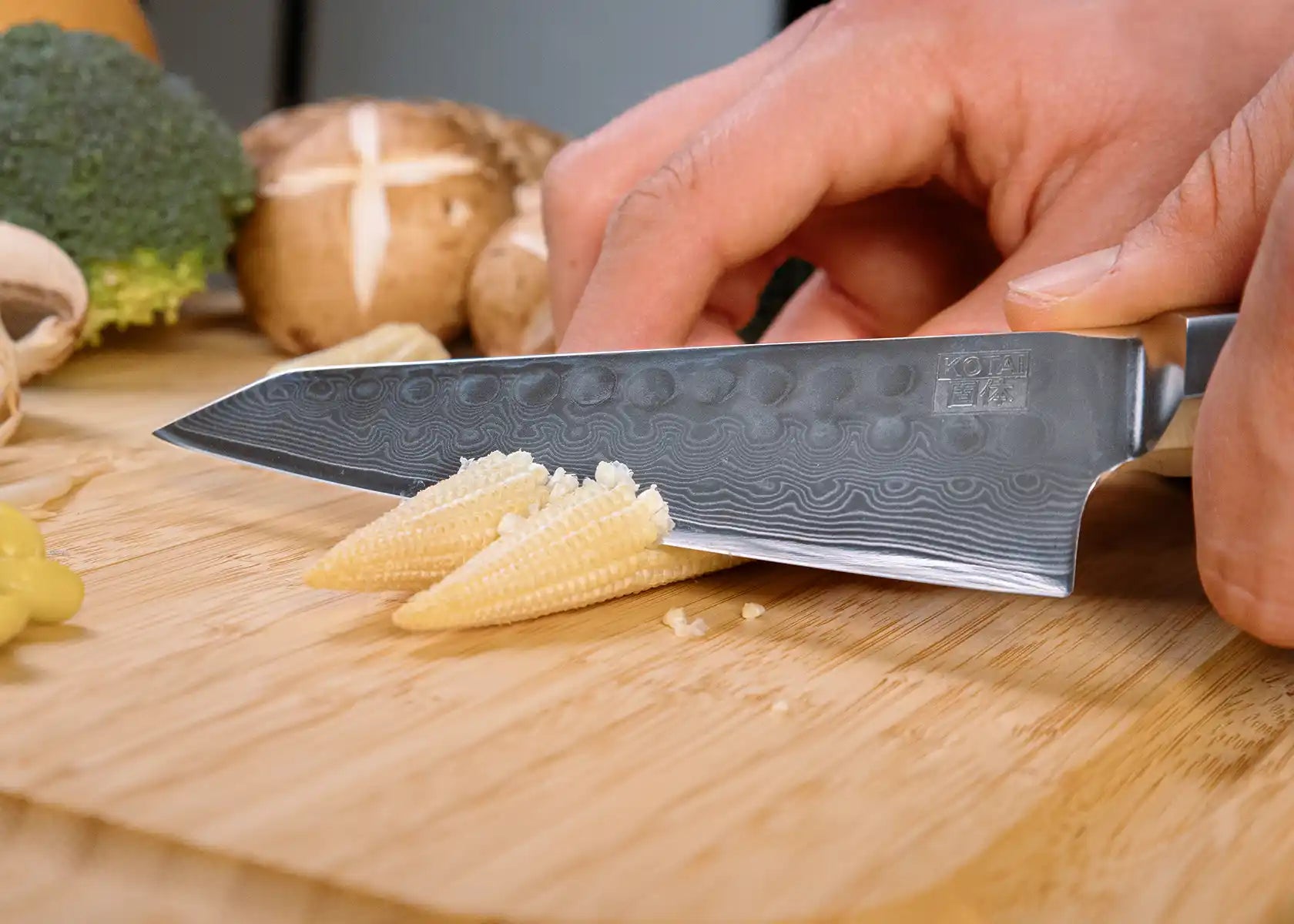 13.5 cm Petty knife with AUS-10 Damascus blade and ebony handle.