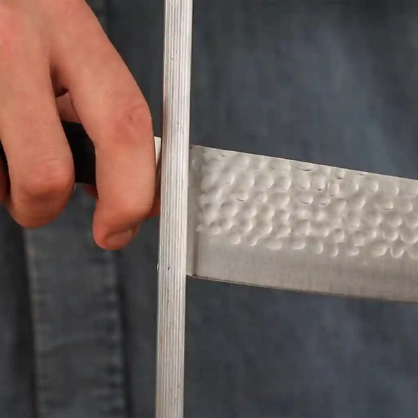 The model is holding the honing steel at a 15 degree angle to the knife.