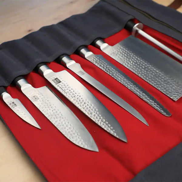 KOTAI's leather roll up bag holding 6 knives including cleaver and 1 honing steel.