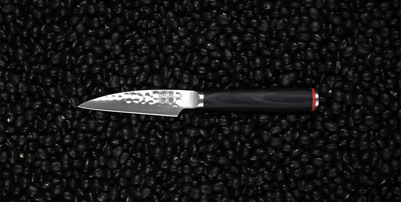 KOTAI's paring knife also known as peeling knife displayed on a black background.