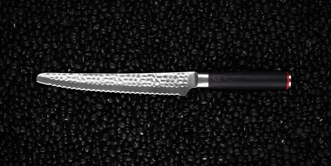 KOTAI's serrated bread knife displayed on a black background.