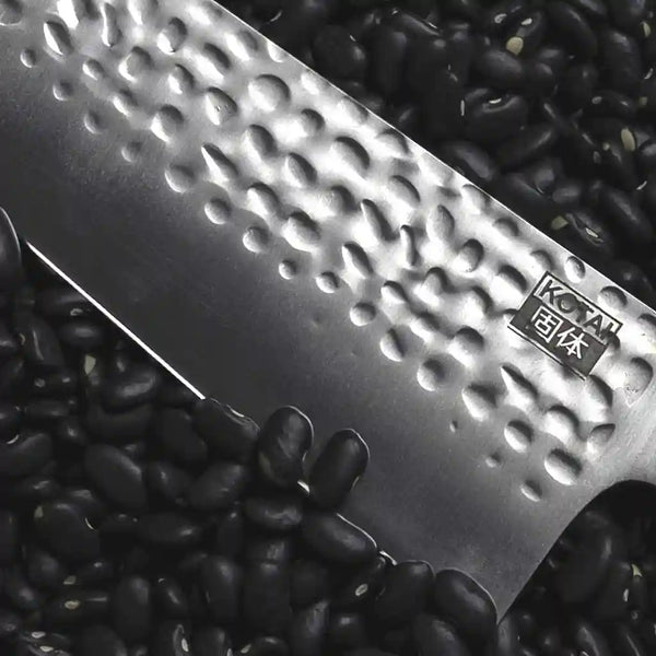 KOTAI Japanese high carbon stainless steel knife displayed on a black background.