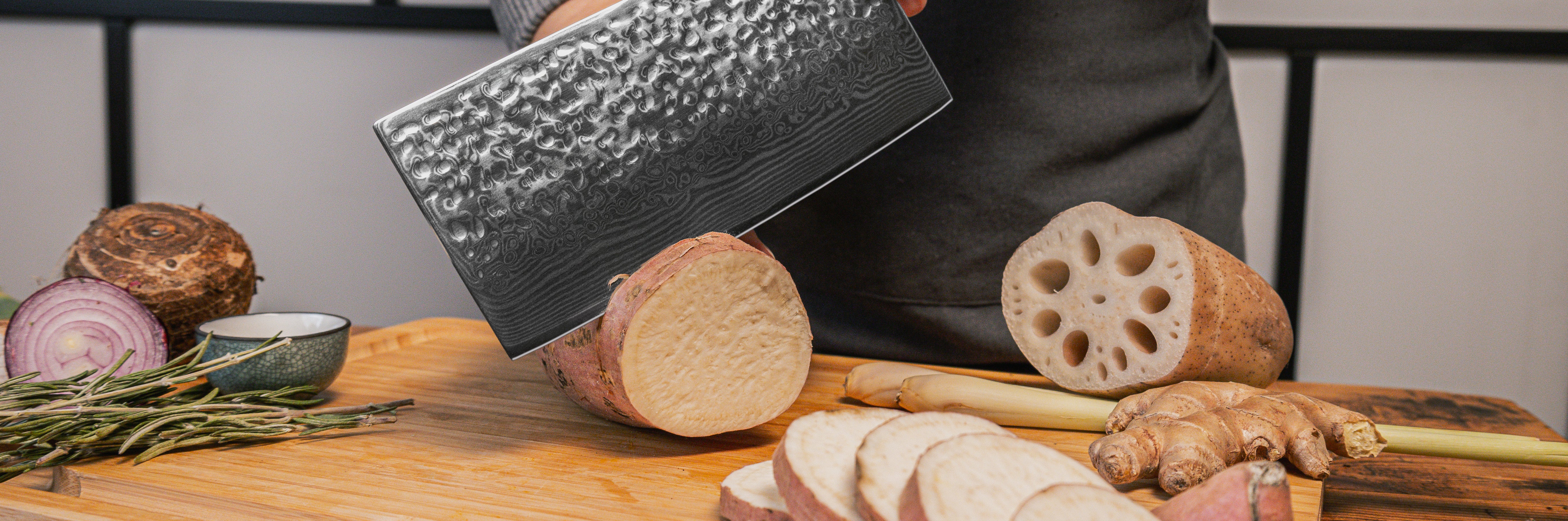 kotai's cleaver knife in damascus steel chopping a sweet potato