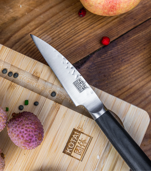 KOTAI's Paring Knife PAKKA Collection is displayed on the KOTAI's bamboo cutting board, with some ingredients.