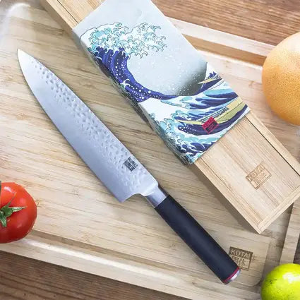 Handmade gyuto knife with its elegant bamboo box and its beautiful hammered blade.