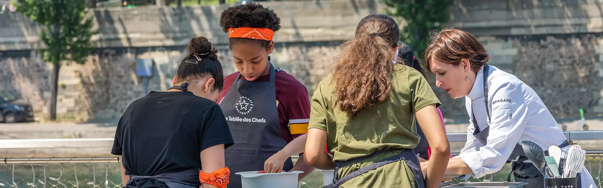 Young chefs from La Tablée des Chefs are focused on their cooking.