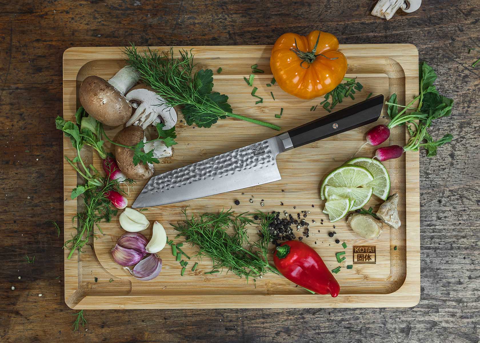 santoku knife and essential kitchen ingredients on a bamboo cutting board